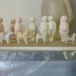 Line of babies and dogs from casts.
