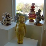 West wall Bed of Roses and Yellow Doll with Marcia's soft toys. Yellow Doll has a fright-wig. She is one of the press moulds.